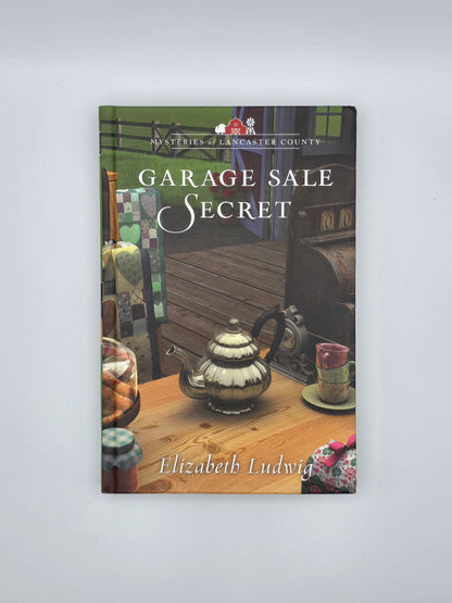 Mysteries of Lancaster County, NC.Garage Sale Secret By Elizabeth Ludwig. Hardcover book, New York 2019.